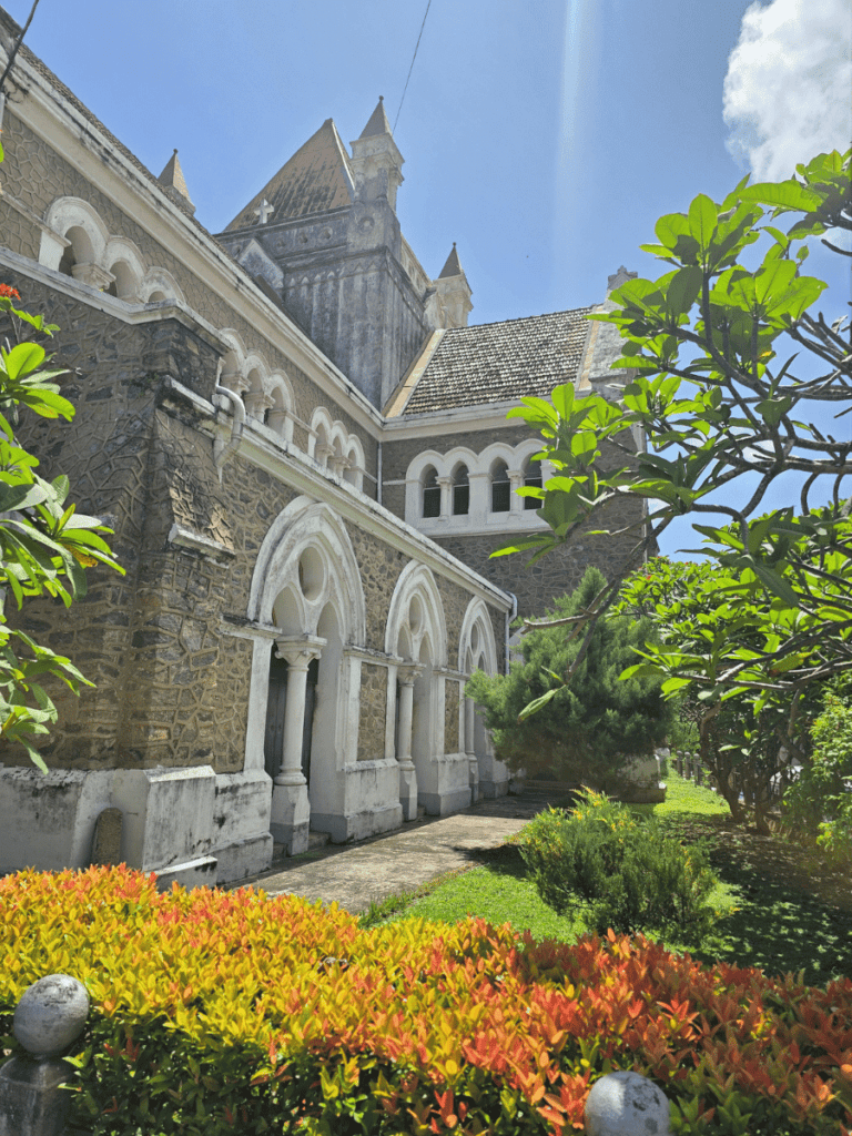 Discover the charm of a historic church in Sri Lanka, showcasing stunning colonial architecture surrounded by lush gardens and vibrant greenery.